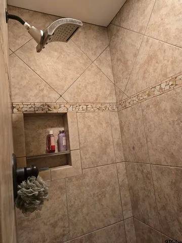 a living room with furniture a fireplace and a ceiling fan