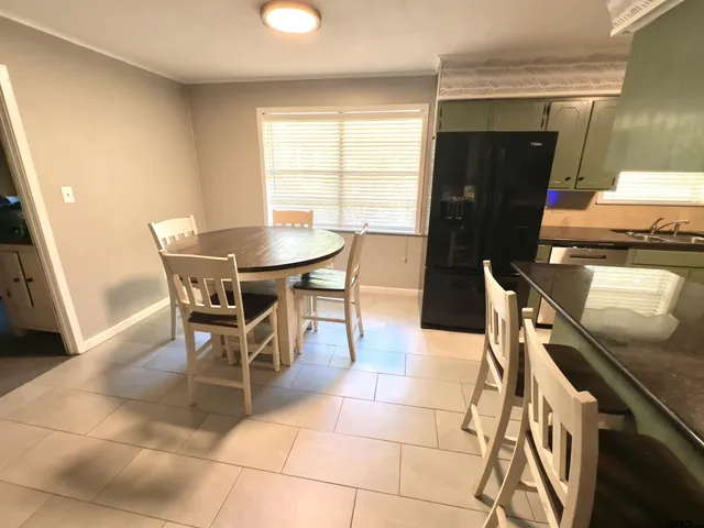 a dining room with furniture and window