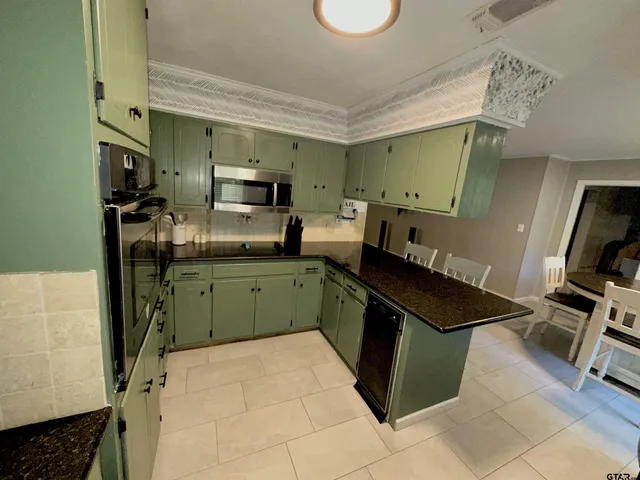 a kitchen with a sink appliances and cabinets