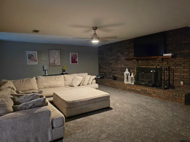 a spacious bedroom with a bed a couch and a fireplace