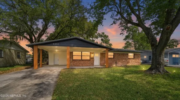 a front view of house with yard and green space