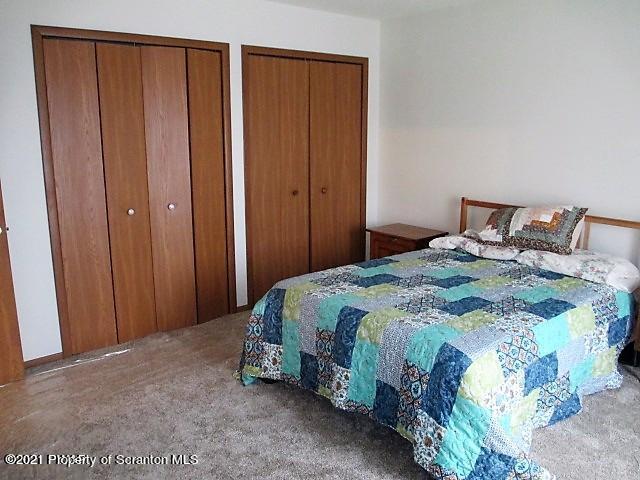 700 Stock Farm Road Lake Ariel, PA 18436 - Photo 12 of 37 a bedroom with a bed and a mirror