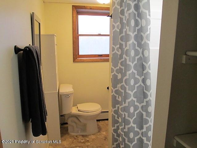 700 Stock Farm Road Lake Ariel, PA 18436 - Photo 23 of 37 a bathroom with a toilet and a shower curtain