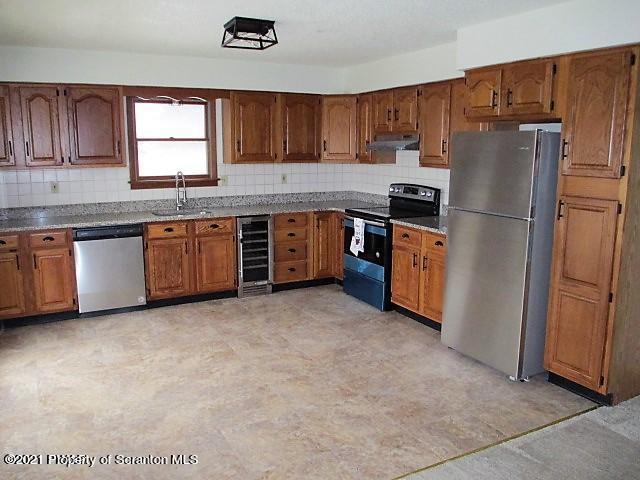 700 Stock Farm Road Lake Ariel, PA 18436 - Photo 3 of 37 a kitchen with stainless steel appliances granite countertop a refrigerator stove top oven a sink and dishwasher