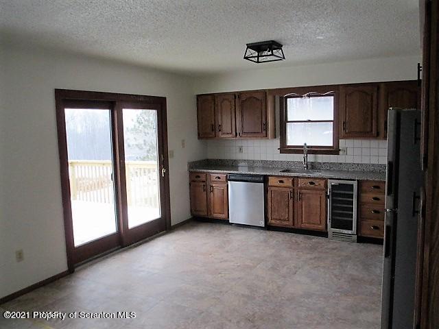 700 Stock Farm Road Lake Ariel, PA 18436 - Photo 4 of 37 a kitchen with stainless steel appliances granite countertop a stove a sink and a large window