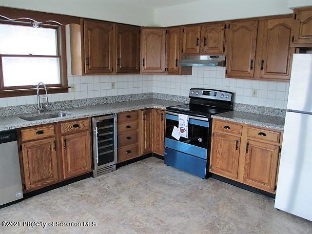 700 Stock Farm Road Lake Ariel, PA 18436 - Photo 5 of 37 a kitchen with stainless steel appliances granite countertop a stove a sink dishwasher and cabinets