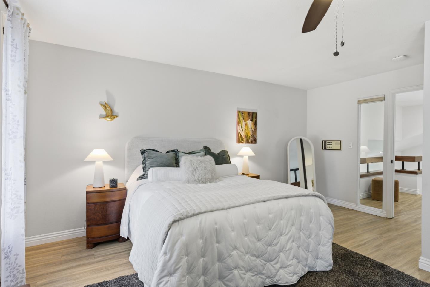1669 Geary Road Walnut Creek, CA 94597 - Photo 31 of 39 a bedroom with a bed and wooden floor