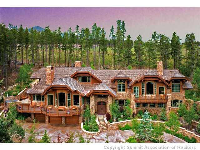 a front view of a house with a yard and lake view