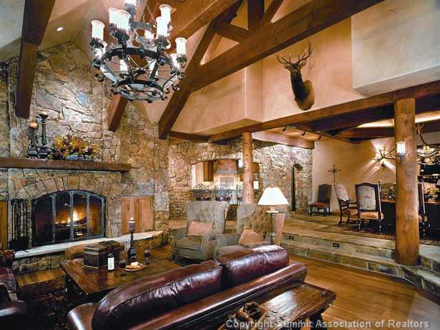 1060 4 O Clock Road Breckenridge, CO 80424 - Photo 4 of 12 a living room with furniture a fireplace and a chandelier