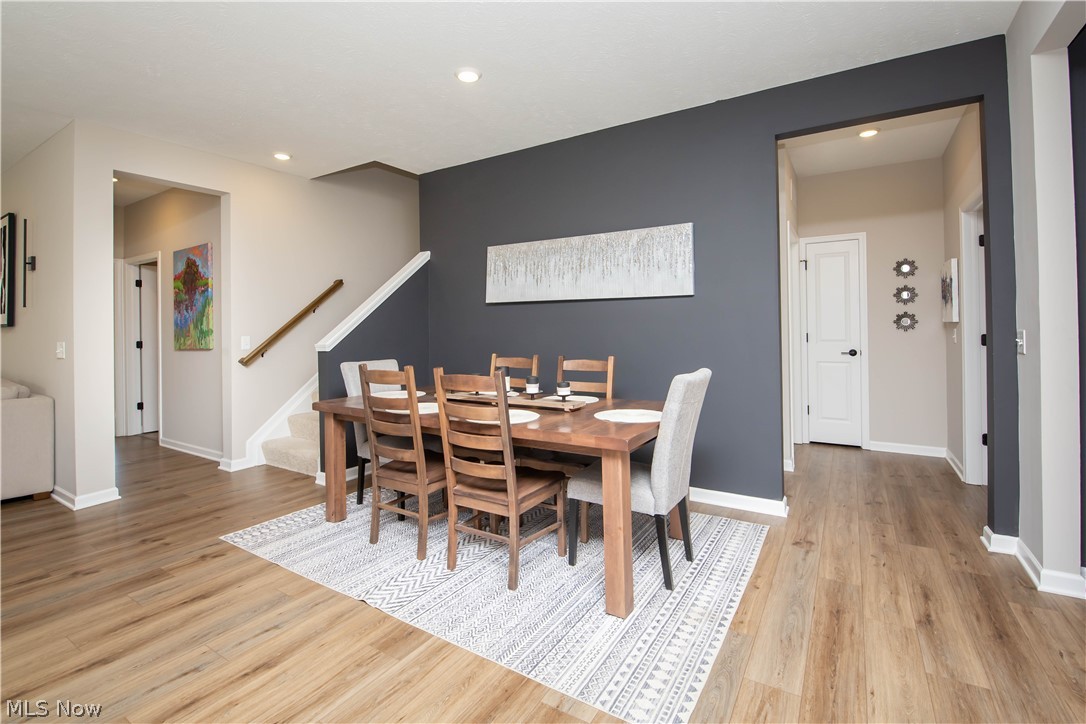 Dining area featuring light wood-style flooring and recessed lighting