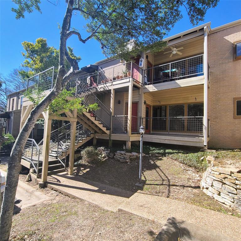 6600 Valleyside Road, Unit D20 Austin, TX 78731 - Photo 1 of 14 Multi-level exterior featuring brick and horizontal siding, multiple balconies with metal grid railings, and an exterior staircase with metal handrails