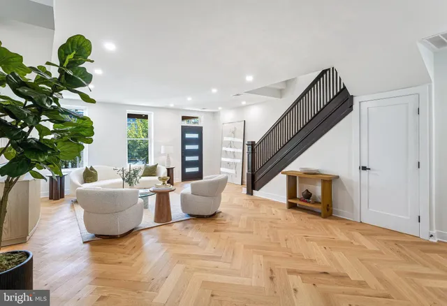 a living room with furniture and a potted plant