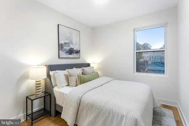 a bedroom with a bed and a painting on the wall