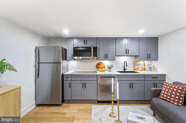 a kitchen with stainless steel appliances granite countertop a refrigerator stove a sink and dishwasher