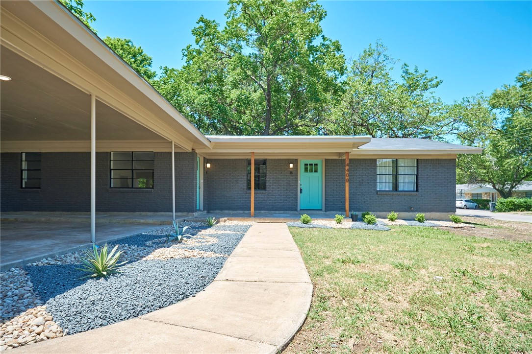4400 Shallowbrook Trail Austin, TX 78744 - Photo 1 of 1 a front view of a house with garden