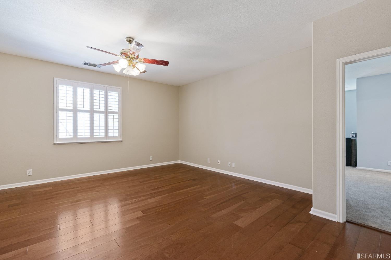 1359 Oak Crest Way Antioch, CA 94531 - Photo 41 of 65 a view of an empty room with wooden floor and a window