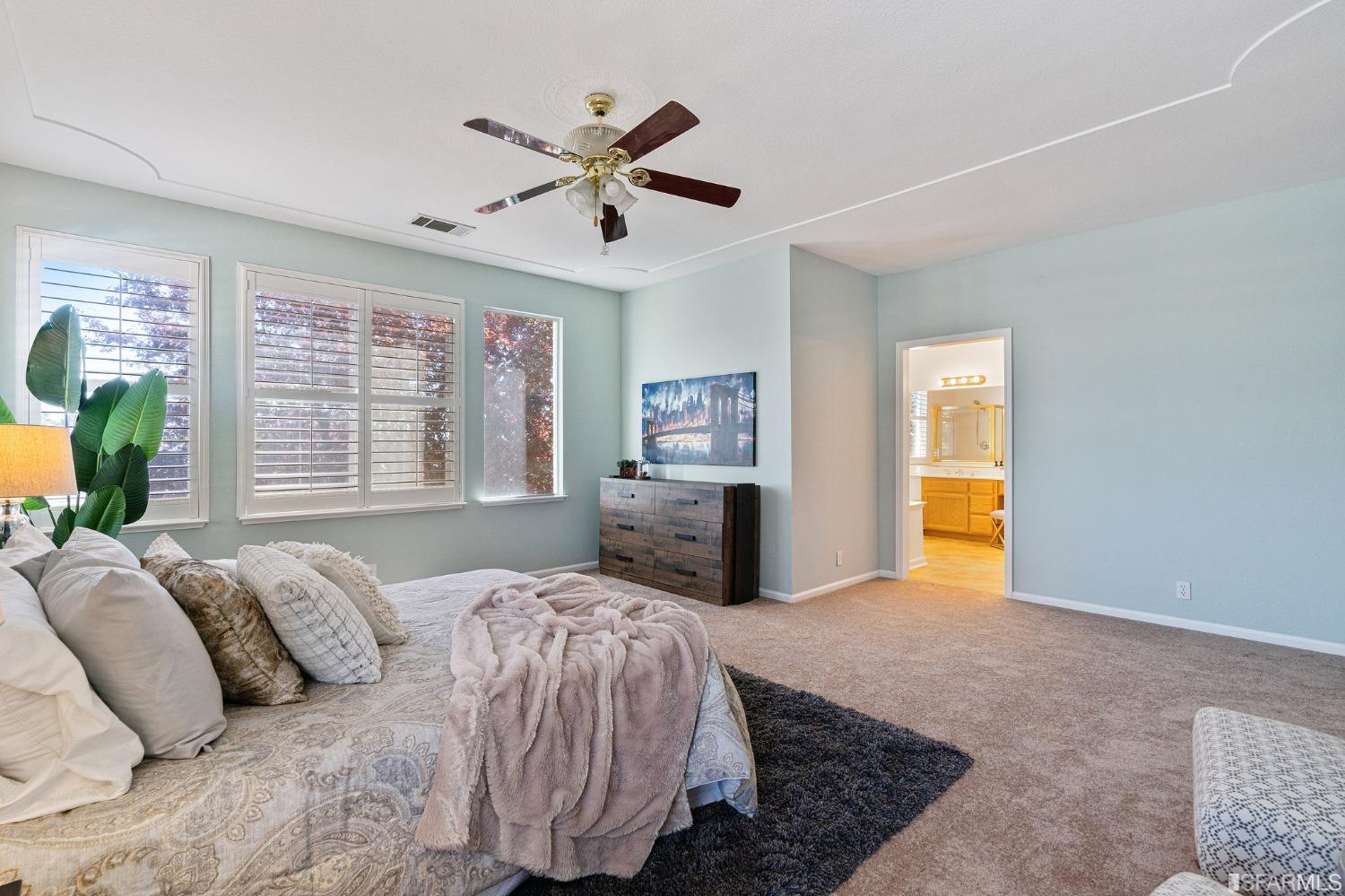 1359 Oak Crest Way Antioch, CA 94531 - Photo 44 of 65 a spacious bedroom with a large bed and a chandelier