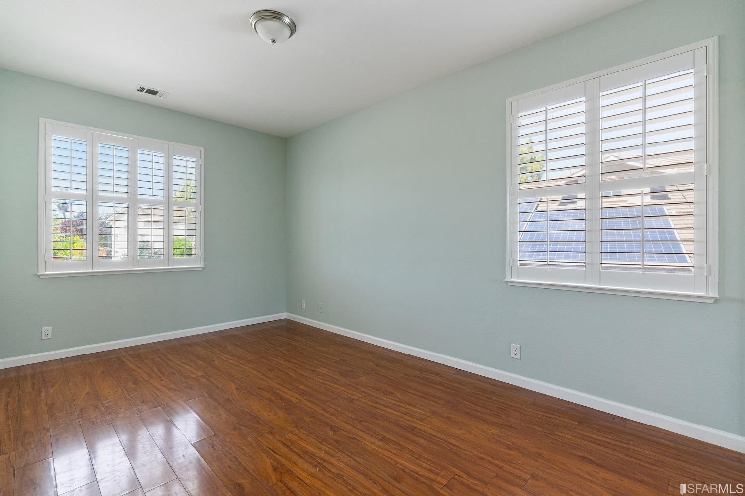 1359 Oak Crest Way Antioch, CA 94531 - Photo 49 of 65 a view of an empty room with wooden floor and a window