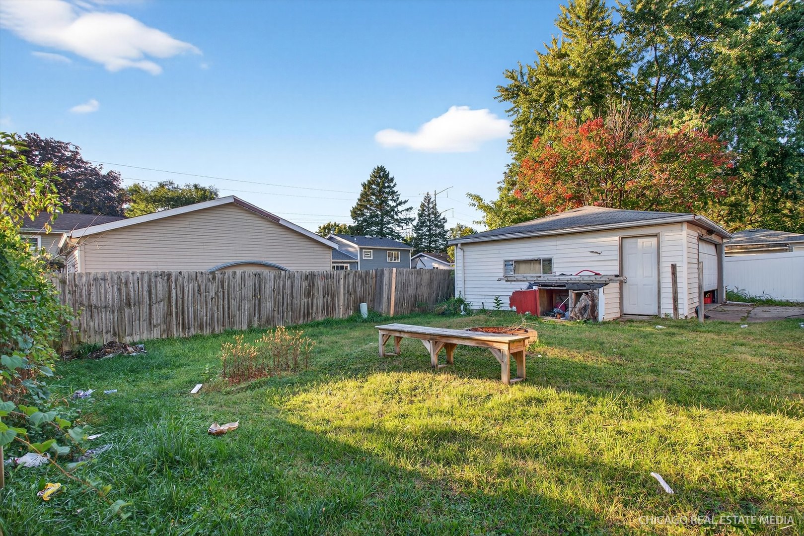 135 Springleaf Drive Bolingbrook, IL 60440 - Photo 15 of 16 a view of a wooden bench sitting in backyard of house