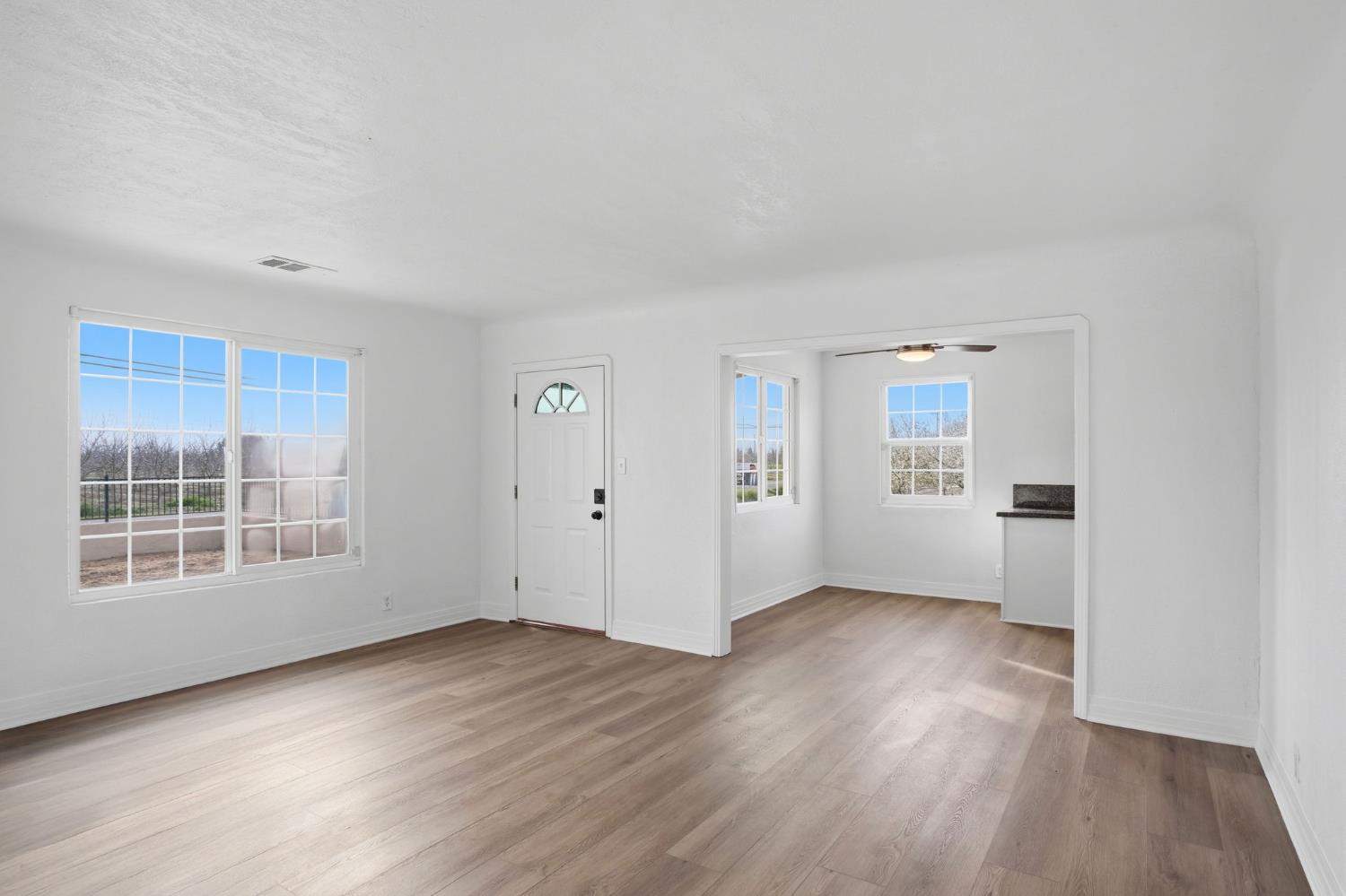 5333 Geer Road Turlock, CA 95382 - Photo 24 of 37 an empty room with wooden floor and windows