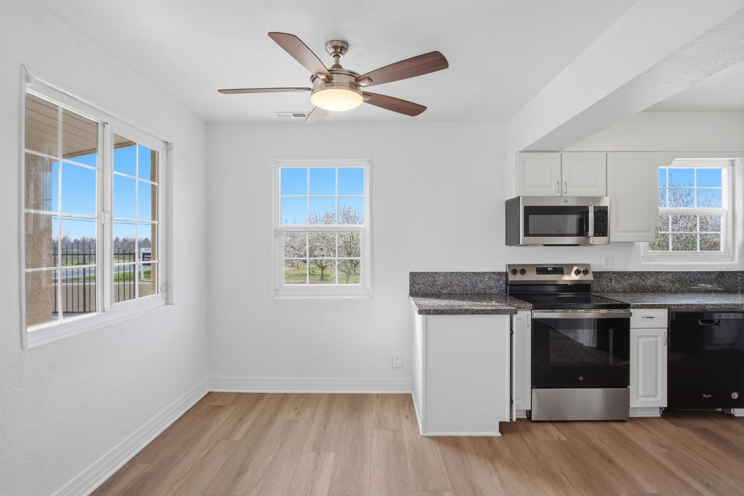 5333 Geer Road Turlock, CA 95382 - Photo 8 of 37 a kitchen with stainless steel appliances granite countertop a stove and a microwave