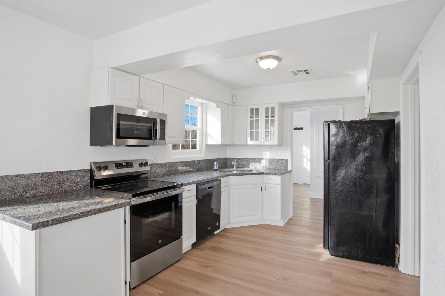 5333 Geer Road Turlock, CA 95382 - Photo 9 of 37 a kitchen with a refrigerator stove and microwave