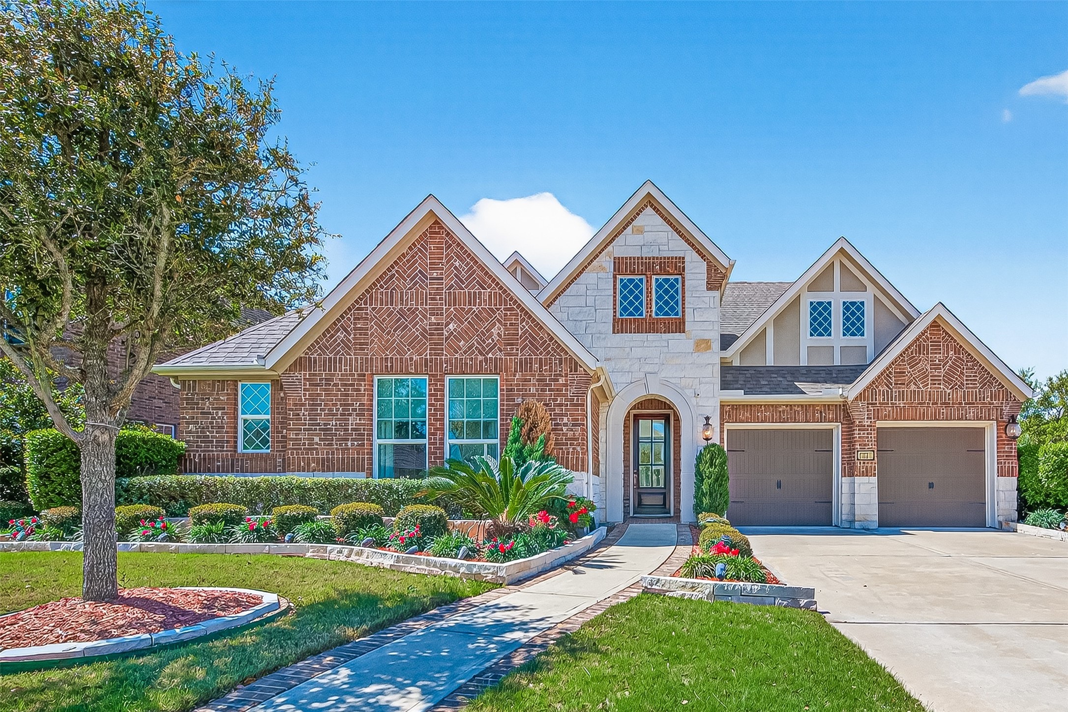 51 Scepter Ridge Sugar Land, TX 77498 - Photo 1 of 42 Welcome to 51 Scepter Ridge in Crown Garden at Imperial in Sugar Land! A welcoming first impression begins with the brick and stone façade, manicured landscaping, and double wide drive setting the tone before even opening the front door. Imagine driving up each day to a home that feels polished, warm, and inviting.