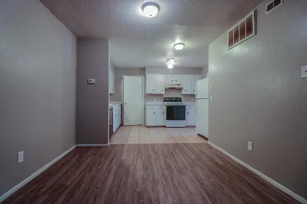 a view of a kitchen with wooden floor and a sink