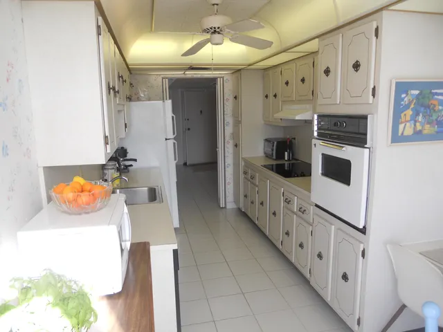 a kitchen with stainless steel appliances a stove a microwave and a refrigerator