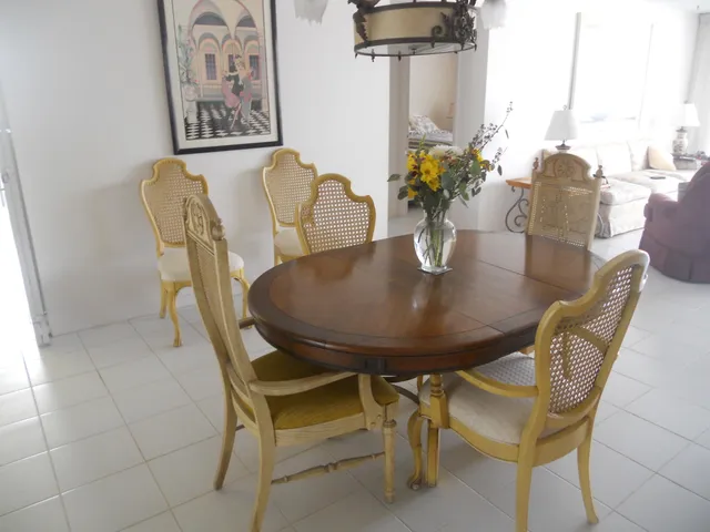 a view of a dining room with furniture and a potted plant
