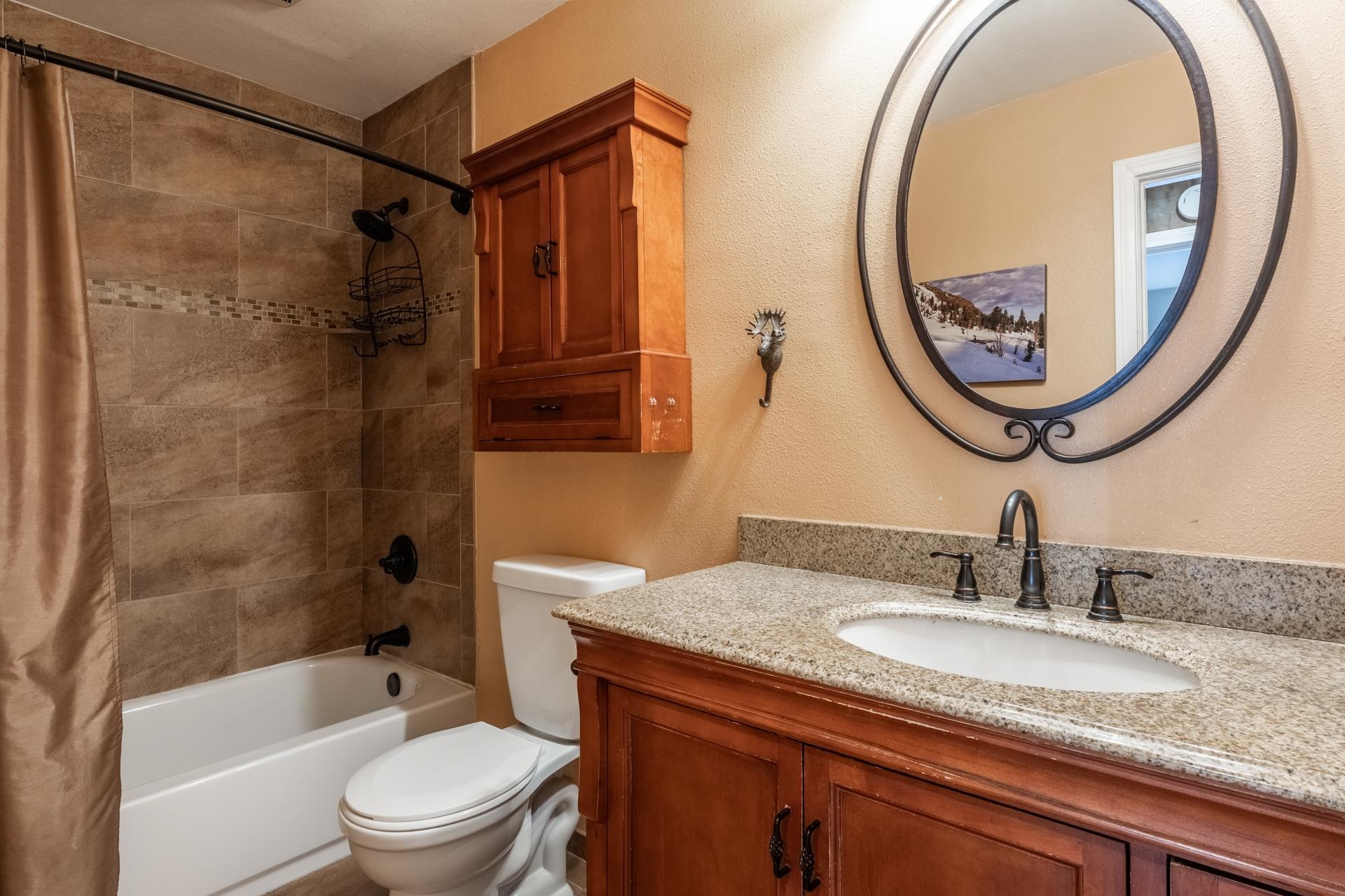 2113 Meridian Boulevard, Unit 141 Mammoth Lakes, CA 93546 - Photo 14 of 23 Bathroom with shower / bath combo, a textured wall, and vanity