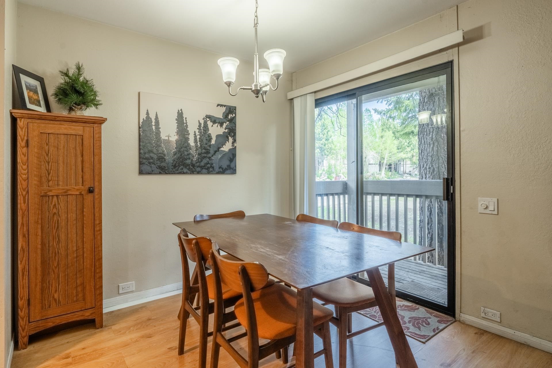 2113 Meridian Boulevard, Unit 141 Mammoth Lakes, CA 93546 - Photo 6 of 23 Dining space featuring light wood-style flooring and a chandelier