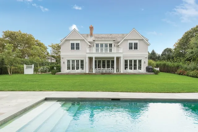 a front view of a house with a yard table and chairs