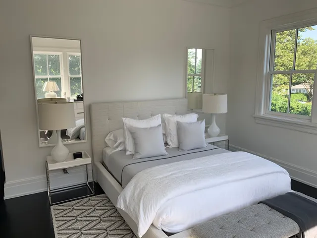 a bedroom with a bed and a lamp