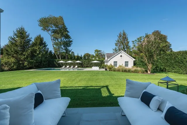 a view of a house with garden and a trees