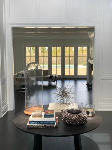 a living room with furniture and a floor to ceiling window