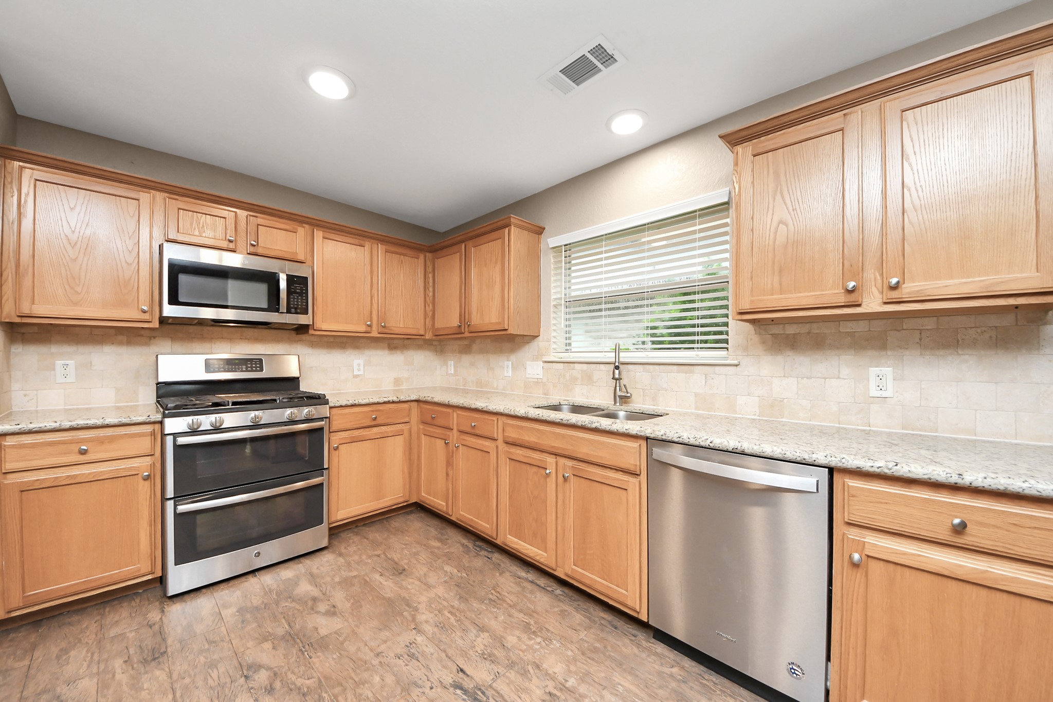 14610 Hazy Ridge Lane Cypress, TX 77429 - Photo 24 of 44 The heart of the home, this stylish kitchen offers plentiful cabinetry, ample storage, and a refrigerator, making meal preparation and entertaining a breeze.