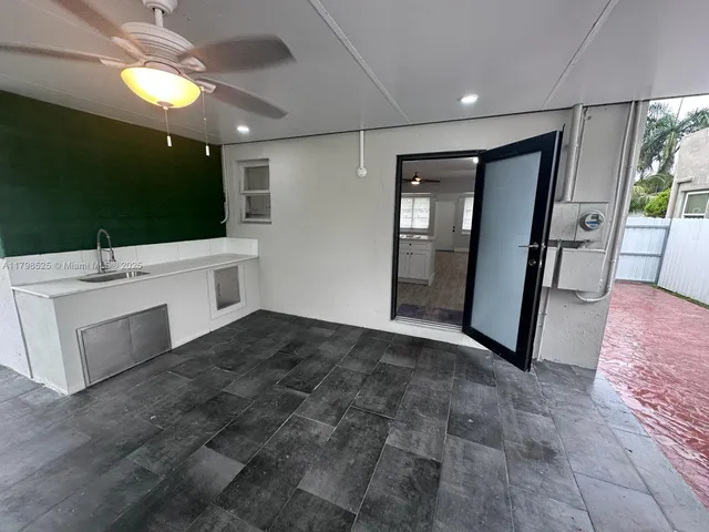 a view of an empty room with a kitchen