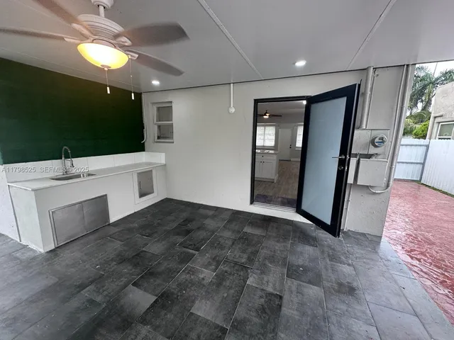 a view of an empty room with a kitchen