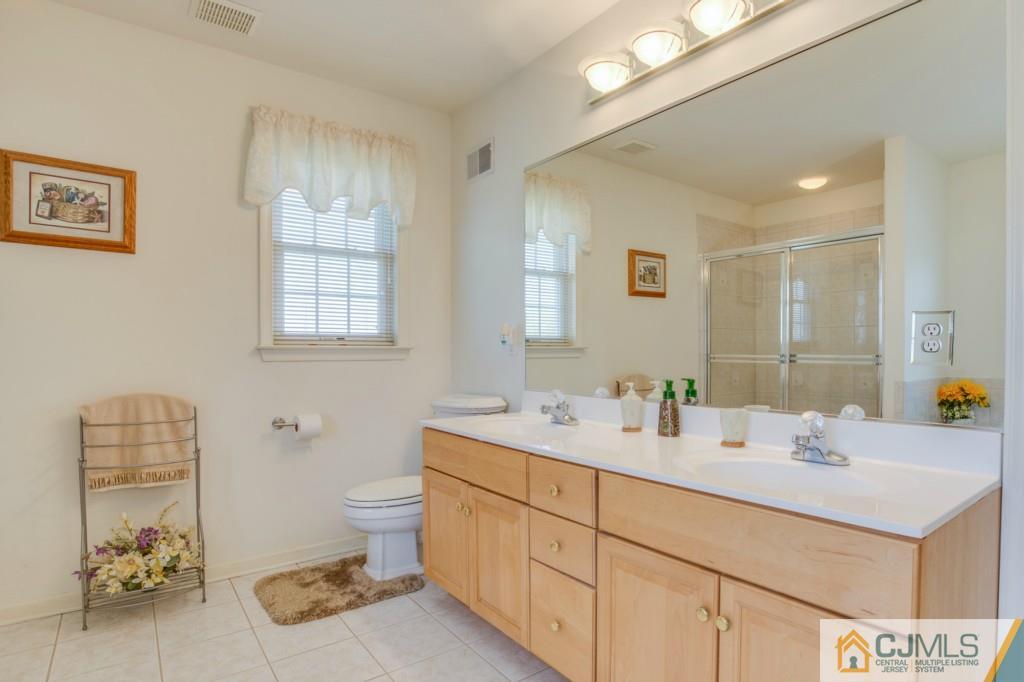85 Sharon Road Robbinsville, NJ 08691 - Photo 12 of 25 a bathroom with a sink double vanity and a toilet