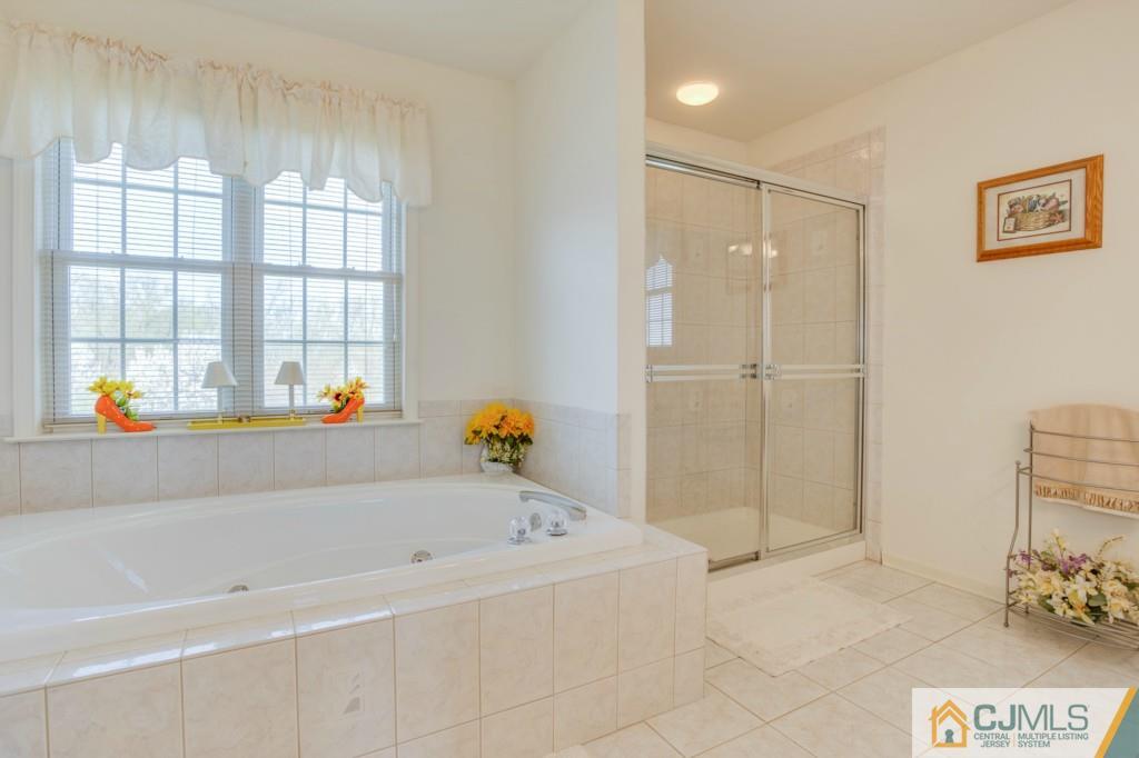 85 Sharon Road Robbinsville, NJ 08691 - Photo 13 of 25 a bathroom with a bathtub and a shower