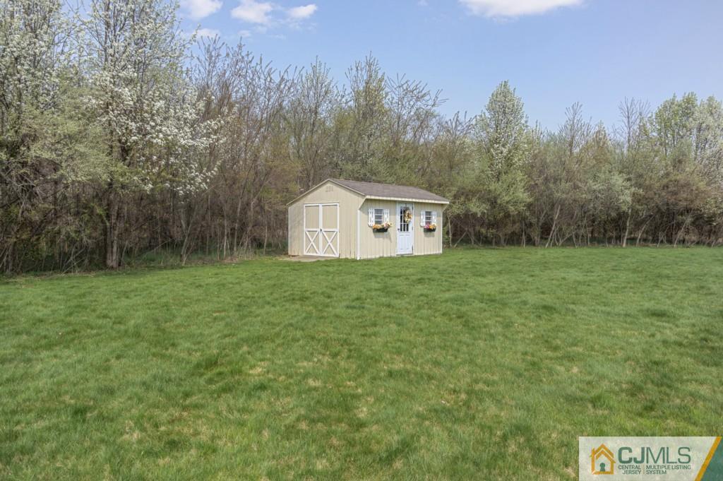 85 Sharon Road Robbinsville, NJ 08691 - Photo 16 of 25 a view of house with backyard and trees