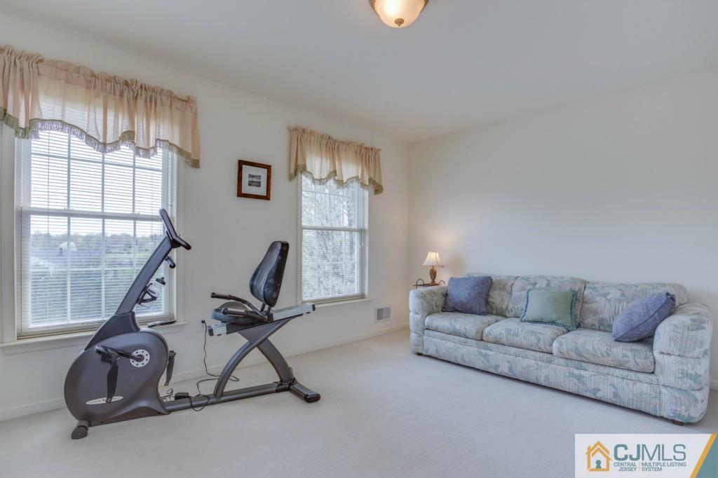 85 Sharon Road Robbinsville, NJ 08691 - Photo 17 of 25 a living room with furniture a air conditioner vent and a window