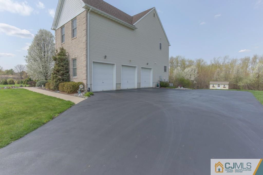 85 Sharon Road Robbinsville, NJ 08691 - Photo 25 of 25 a view of a house with a yard and garage