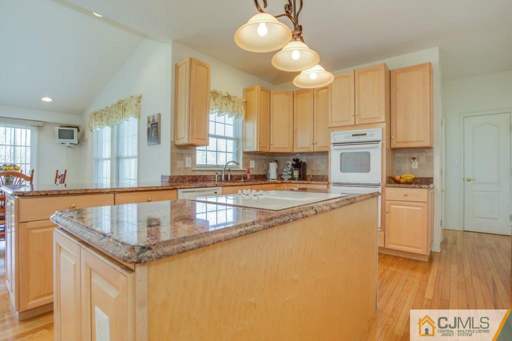 85 Sharon Road Robbinsville, NJ 08691 - Photo 7 of 25 a kitchen with granite countertop a sink a stove and cabinets