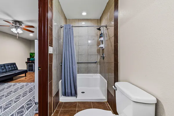 a white toilet sitting next to a bathroom sink
