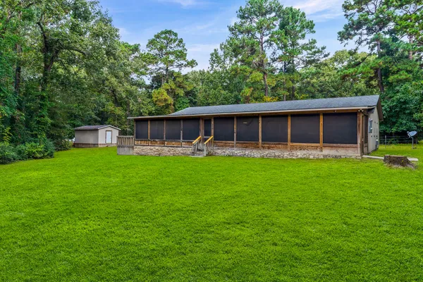a view of an house with backyard space and garden