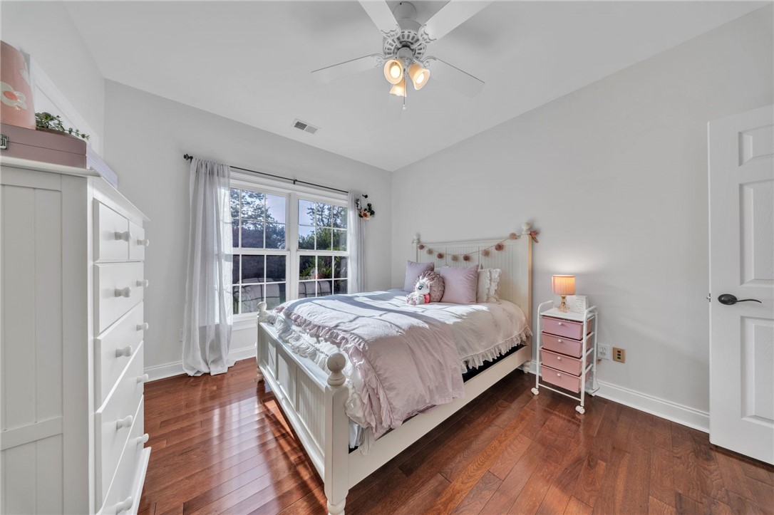 102 Country Walk Lane Clemson, SC 29631 - Photo 27 of 39 Hardwood flooring extends throughout this well-lit bedroom, illuminated by ample natural light.