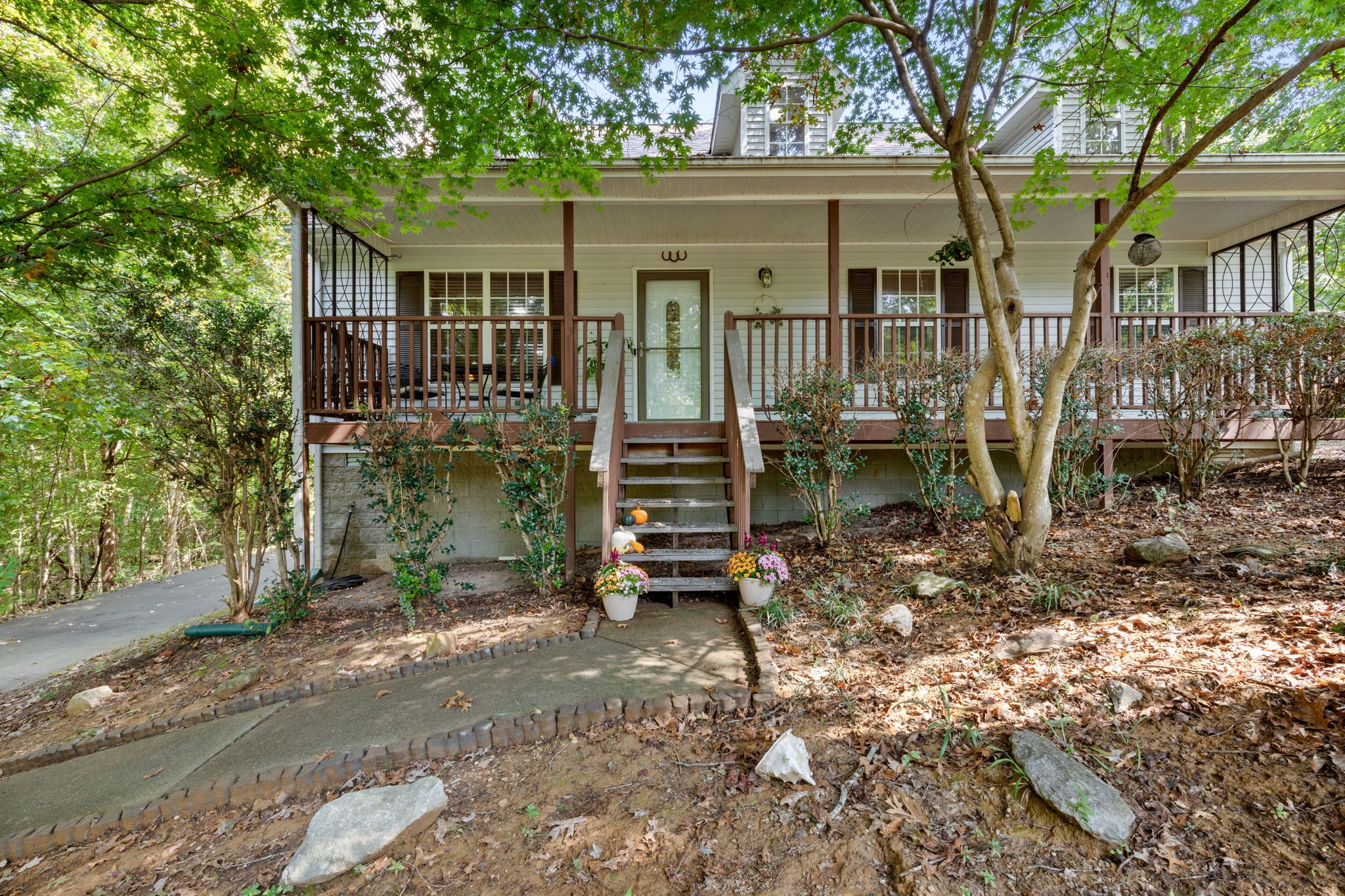 a backyard of a house with barbeque oven table and chairs