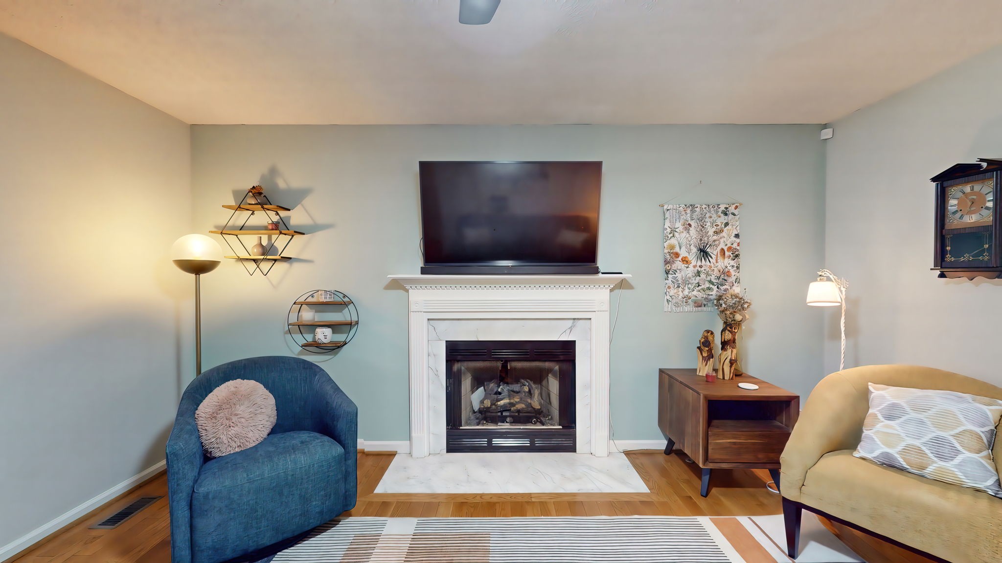 137 Gaskins Road Dickson, TN 37055 - Photo 19 of 58 a living room with furniture a fireplace and a flat screen tv